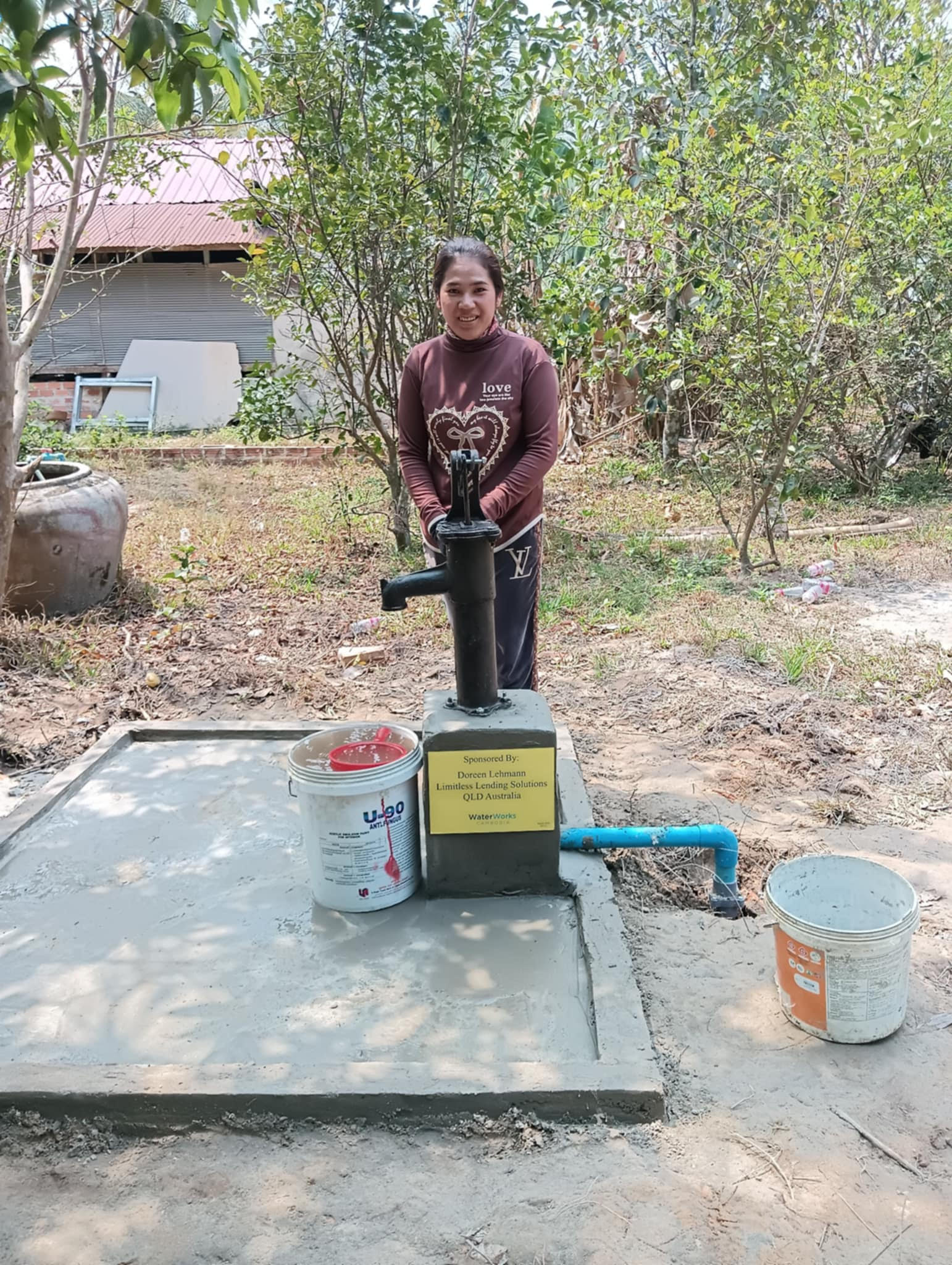 Woman at water well Cambodia